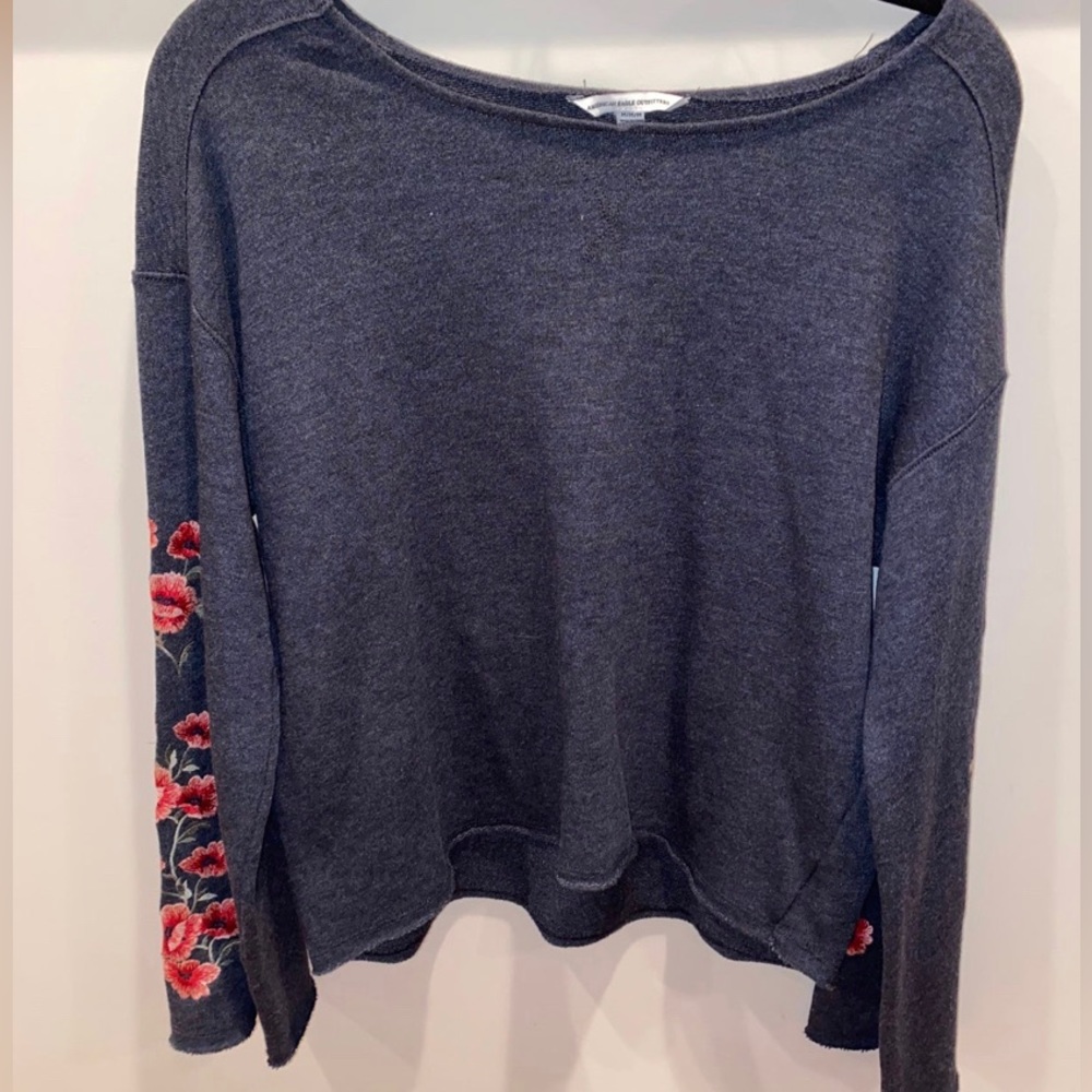 soft gray sweater, pink/red flowers on sleeves